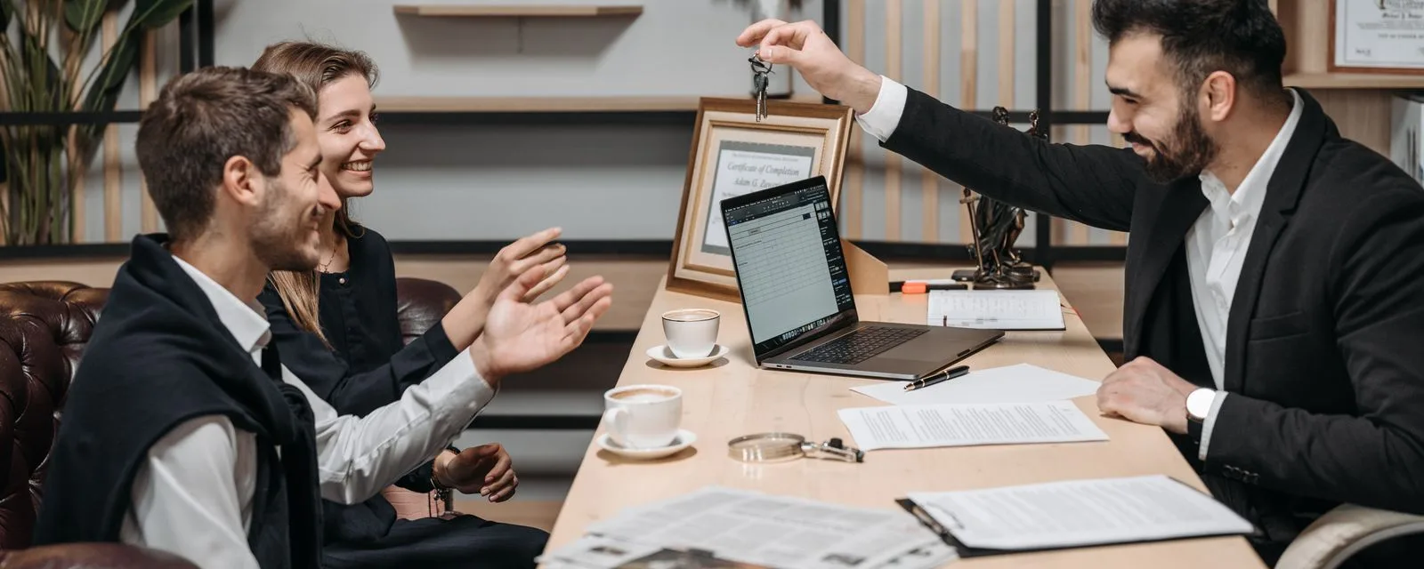 Keys changing hands across a brokerage desk