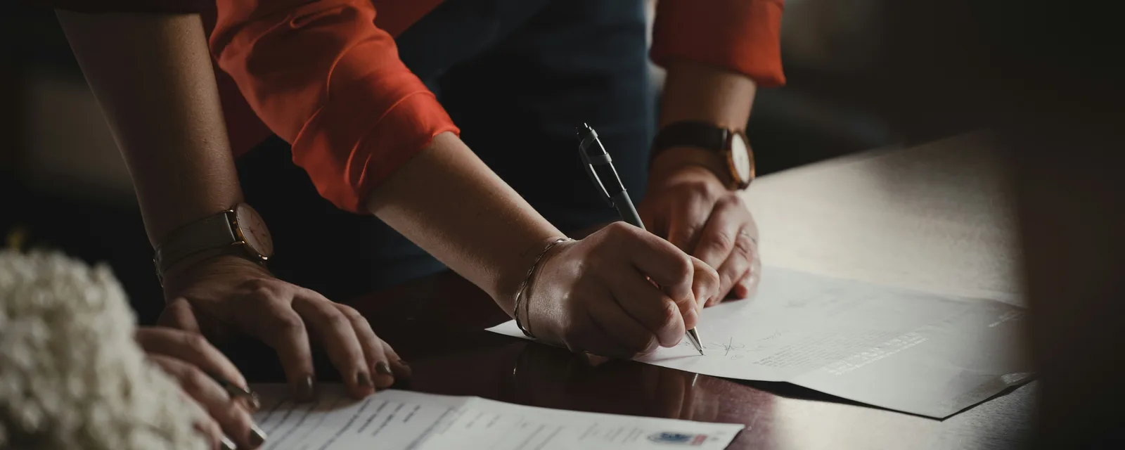 Signing court-sale documents at a table